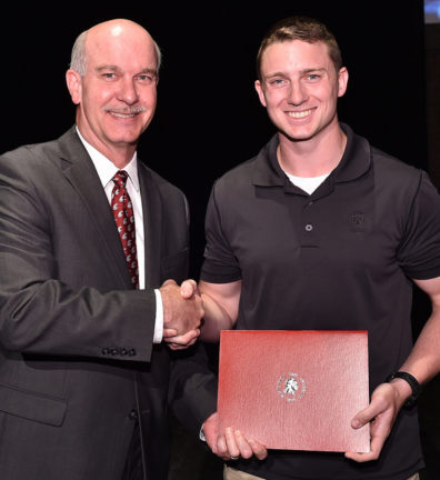 Tyler Lanfear receives his award from Dean Daryll DeWald